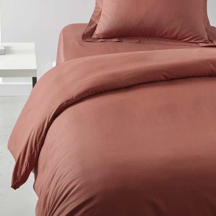 Nahaufnahme: Bettdeckenbezug in Terrakotta. Schlafzimmer Textilien mit kissen und weicher Textur.