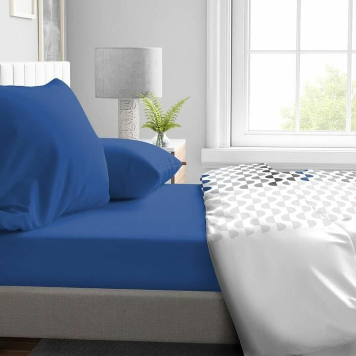 Blaues Spannbetttuch HOME LINGE PASSION mit glatter Oberfläche auf einem Bett. 