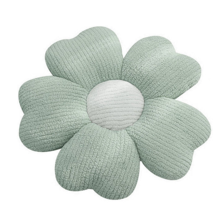 Grünes Kissen in Blumenform mit weicher Textur und weißer Mitte.