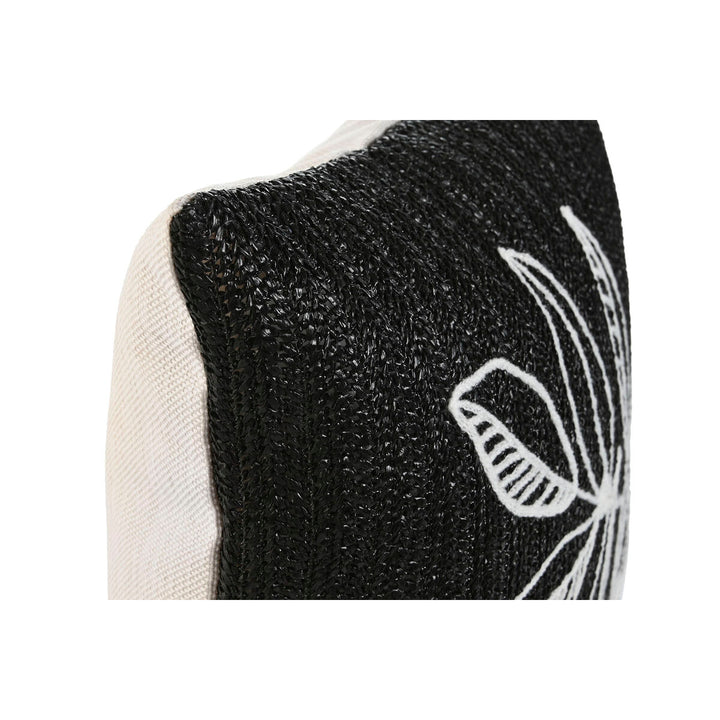 Nahaufnahme: Weißes Kissen mit schwarzer Textur und floralem Muster.