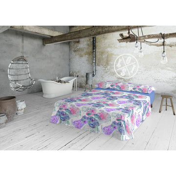 Blaues Lois TROPIC Bettwäsche-Set für Einzelmatratze mit floralem Muster im Schlafzimmer.
