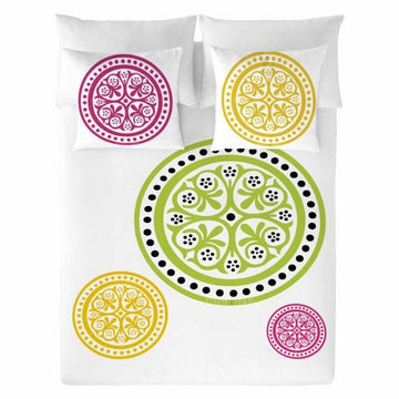 Devota & Lomba Bettwäsche mit floralen Kreisen in Grün, Gelb und Rosa auf weißem Bettdeckenbezug.