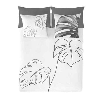 Bettdeckenbezug Naturals mit Monstera-Blatt Design. Weißer Bezug mit schwarzen Linien und grauen Kissenbezügen.