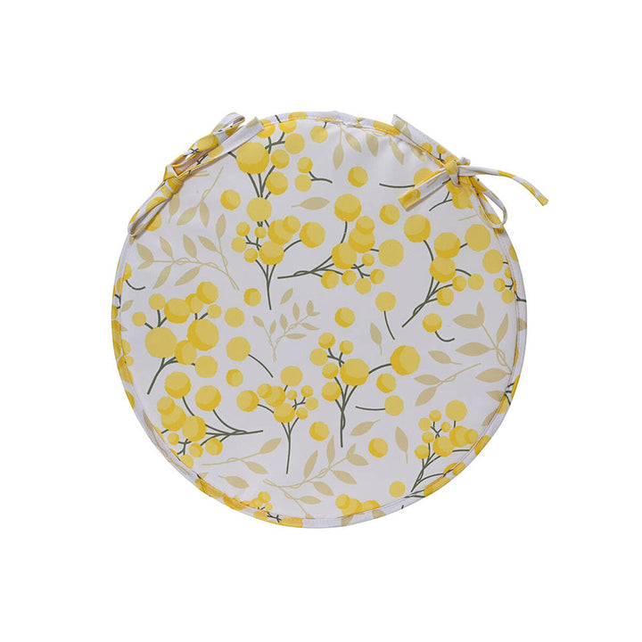 Rundes Decoris Kissen mit gelbem Blumenmuster und Bindebändern.