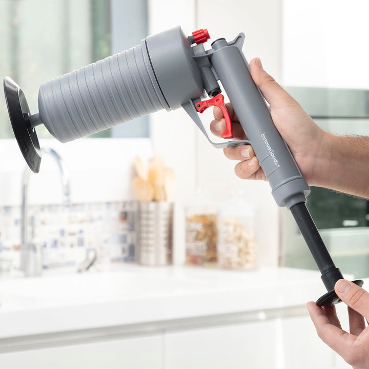 Graue KlinGun InnovaGoods Druckluftpistole zur Abflussreinigung mit Adaptern.