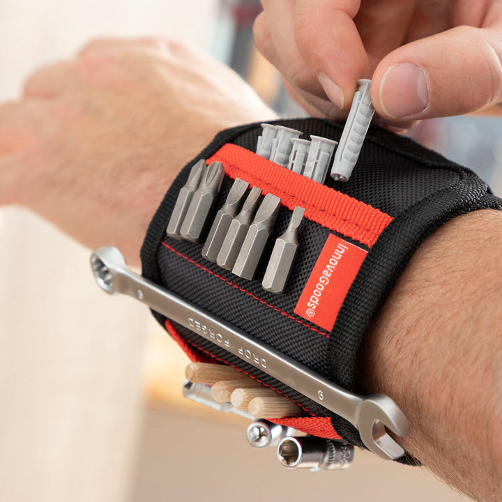 Magnetisches Heimwerker-Armband am Handgelenk mit Werkzeugen und Bits befestigt.